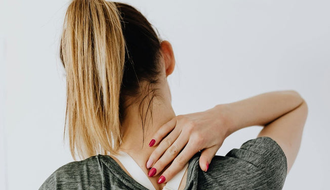 A woman in pain massages her back pain – Dr. Dabber